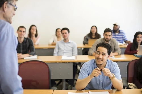 Classroom of students smiling at Dr. Zimmerman