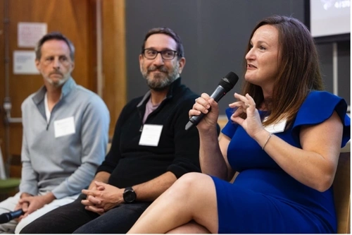 Lara Paparo seated alongside Thinkist executives Jared Wells and Mark Manasse, speaking into a microphone