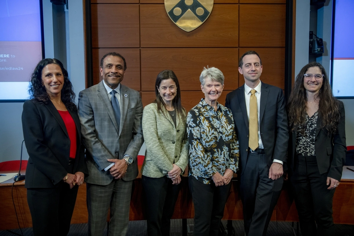 Penn GSE and Penn Carey Law deans stand posing with the panelists from the Goldberg/Christman lecture along with the lecture’s founder and namesake