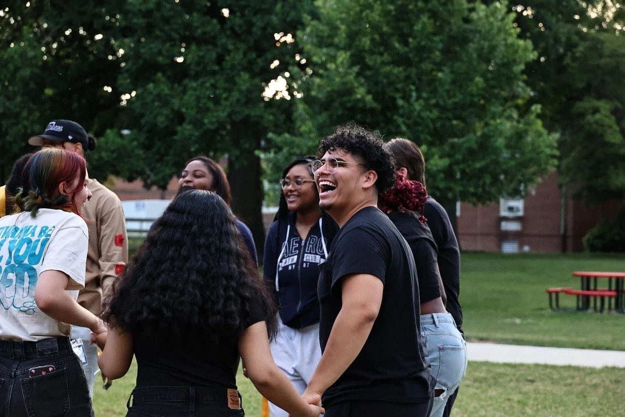 students laughing and holding hands
