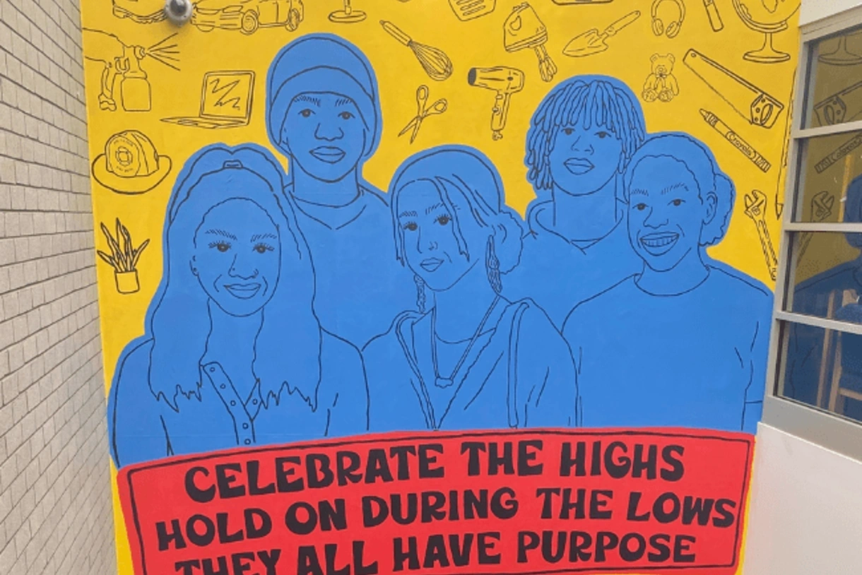 Photograph of mural depicting a group of students above the following quote: "Celebrate the highs. Hold on during the lows. They all have purpose.