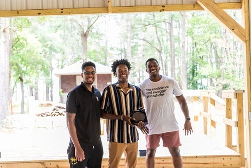 three men posing for photo together