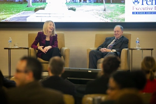 Penn President Amy Gutmann and professor Robert Zemsky talk on a stage.