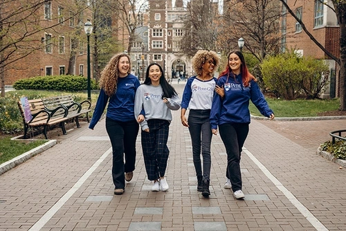 Students walking and laughing in UPenn merchandise