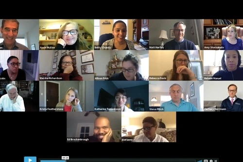 A video call with 17 Penn GSE faculty is screenshotted. Each person’s video screen appears in a small box, with many faces smiling or in mid-conversation, and home offices or living rooms are in each of the 17 backgrounds.