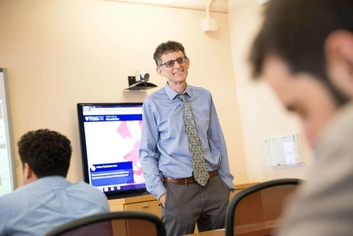 Jonathan Zimmerman standing in front of a class smiling