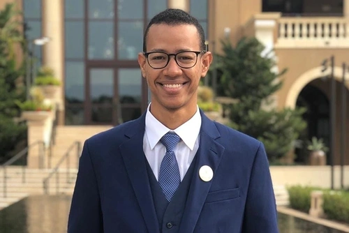 Abdulrahman Bindamnan smiling in a suit
