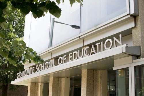 The Graduate School of Education sign on the School's building.