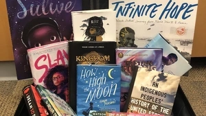 A selection of books from the 2019 Best Books list arranged in a suitcase