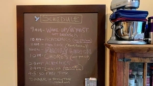 A family schedule written on a chalkboard. 