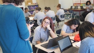 Teacher talking to students in a classroom