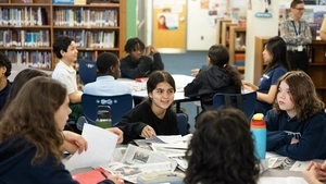 Middle school-aged children engaged in group discussion at Penn Alexander Elementary