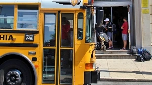 A school bus pulls up to a school. 
