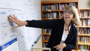 Jeanne Smith points to words on a white board during her reading lessons